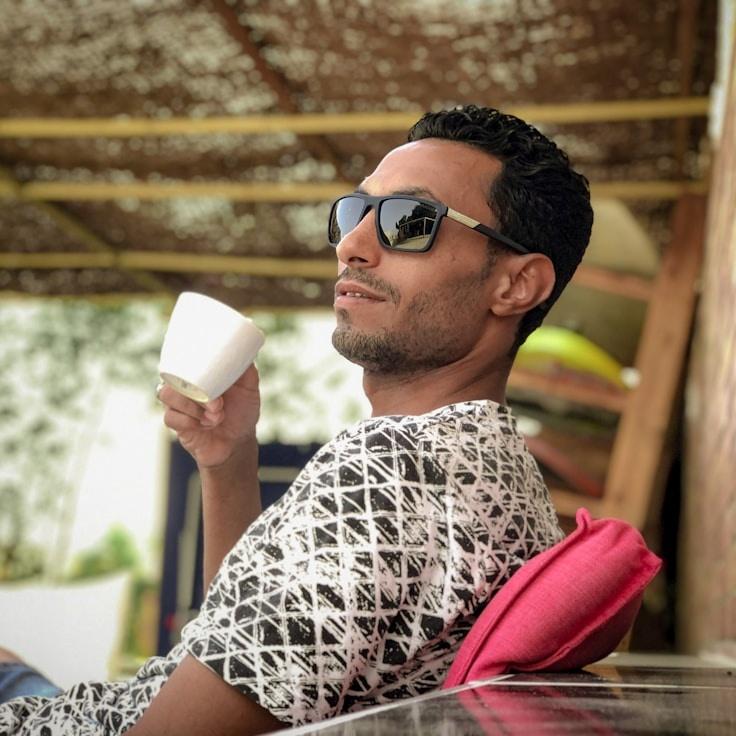 Kara Mehta, Lead Design Curator at AtlasGardenShell, reviewing corporate floral arrangements